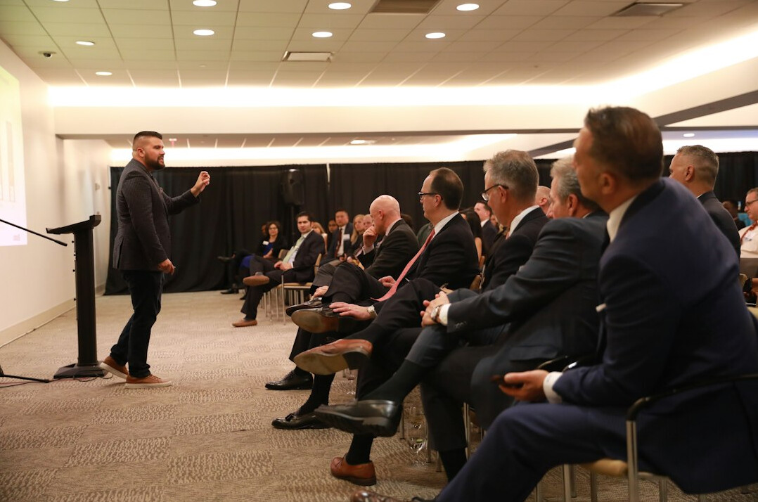 man giving speech to colleagues