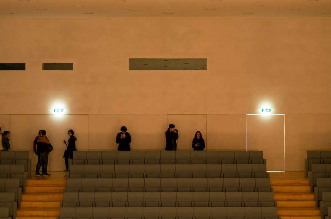 Small group of people listening attentively in a room