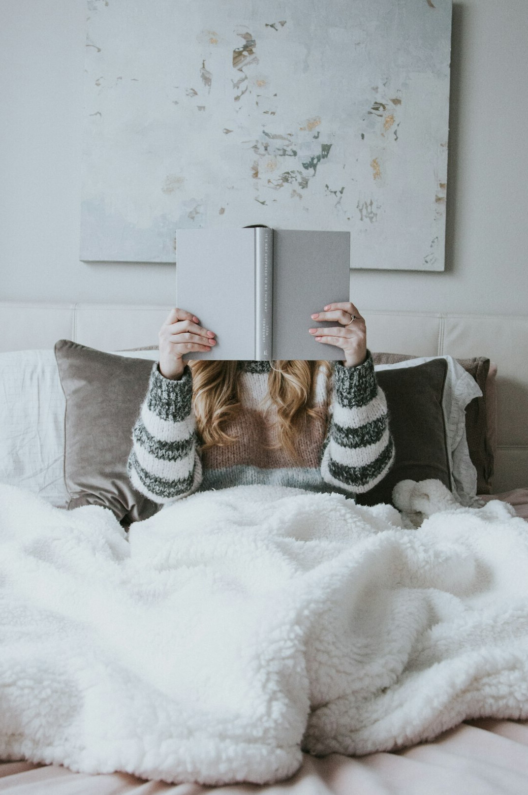 person reading book at home
